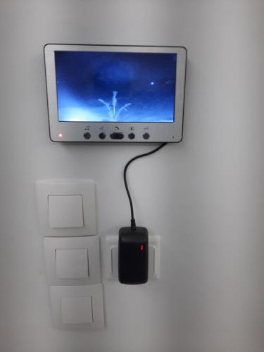 a computer monitor with a mouse attached to a wall at VILLA NAYFAL in Saly Portudal