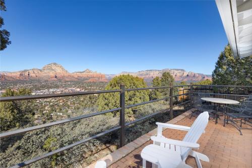 a balcony with two chairs and a table with a view at Sky Ranch Lodge in Sedona