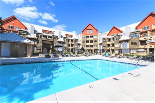 a swimming pool in the courtyard of a apartment complex at Lake Placid Lodge by Elevate Vacations in Whistler