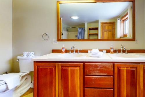 a bathroom with two sinks and a mirror at Heart House in Gilford