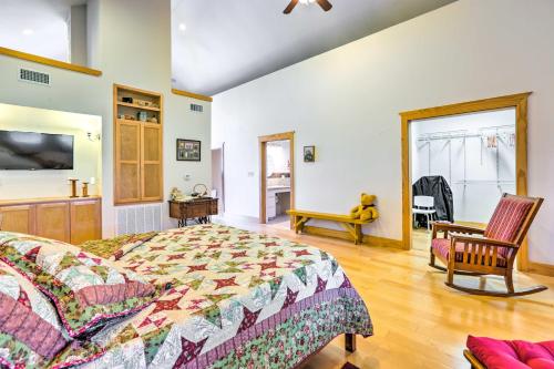 a bedroom with a bed and a chair at Johnson City Home with Hot Tub - Close to Wineries! in Johnson City