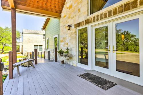 a porch of a home with a bench and sliding glass doors at Johnson City Home with Hot Tub - Close to Wineries! in Johnson City