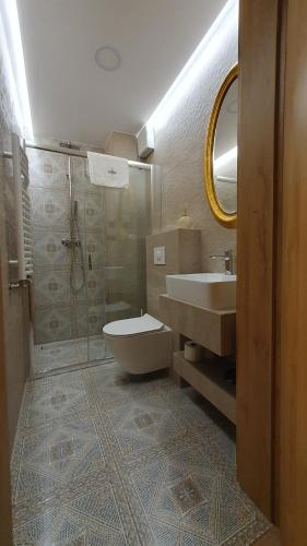 a bathroom with a sink and a toilet and a shower at Apartamenty Nowa Osada - by VillaOlimpijska2 in Wisła