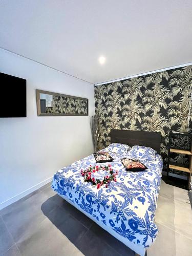 ein Schlafzimmer mit einem blauen und weißen Bett mit Blumen darauf in der Unterkunft Luxury Dreams Balneo in Le Cannet