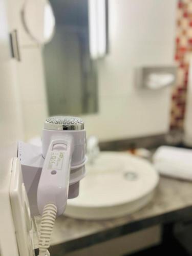 a phone on a counter next to a toilet at Au Coeur Des Bulles in Loches-sur-Ource
