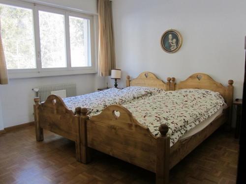 a bedroom with a wooden bed in a room at Residence Eden Roc in Crans-Montana