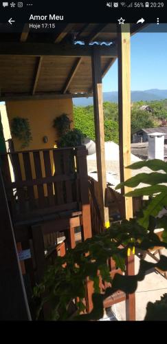 a view of a porch with a view of the ocean at Morada Sol e Lua Container Guarda do Embaú com Ar condicionado in Guarda do Embaú