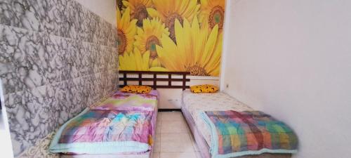 Кровать или кровати в номере Hotel Bali Graha Dewata Agung