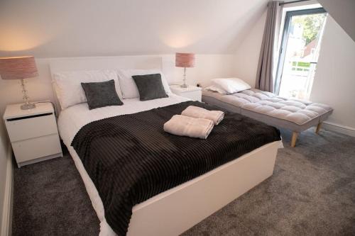 ein Schlafzimmer mit einem großen Bett und einem Sofa in der Unterkunft Rosey Lodge - One Bed Cousy Flat - Parking, Netflix, WIFI - Close to Blenheim Palace & Oxford - F5 in Kidlington