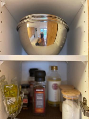 a shelf of a refrigerator with a mirror in it at TOYA LAKEHILL CABIN - The lake view cabin at Lake Toya in Lake Toya