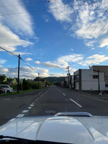 a view from a car windshield of an empty street at TOYA LAKEHILL CABIN - The lake view cabin at Lake Toya in Lake Toya