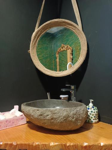 a bathroom with a stone sink and a mirror at Cabezo Buñuel alojamiento Rural in Calanda
