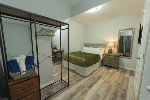 a bedroom with a bed and a mirror at Modern, Luxury 2 Bedroom Apt in Prime Location in Schenectady