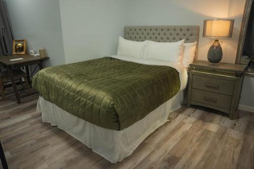 a bedroom with a bed and a desk with a night stand at Modern, Luxury 2 Bedroom Apt in Prime Location in Schenectady