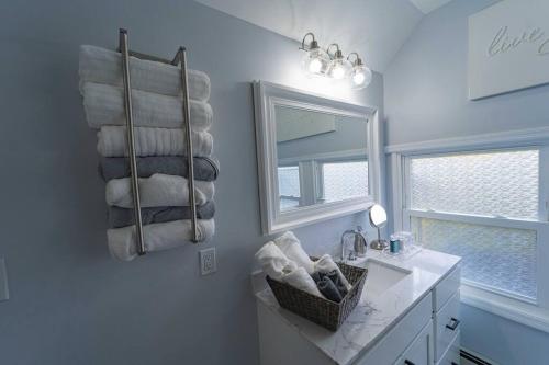 a bathroom with a sink and a mirror and towels at Modern, Luxury 2 Bedroom Apt in Prime Location in Schenectady