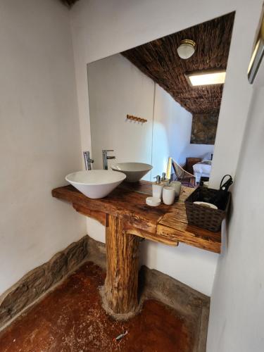 a bathroom with a counter with a sink and a mirror at Masairi in San Pedro de Atacama