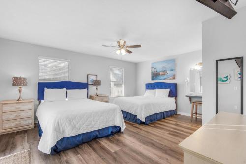 a bedroom with two beds and a ceiling fan at Beach House of Stress Relief in Destin