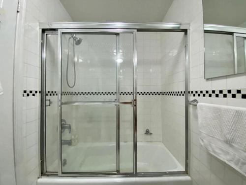 a shower with a glass door in a bathroom at Great Location near Times Square in New York