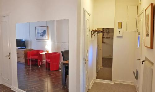 a living room with a table and red chairs at City Apartments Triangeln in Malmö