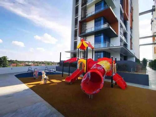a playground with a slide in front of a building at Hanns&FreeWiFi&Washer&Parking &Pool&Sauna&Sunshine Comfort Homstay2 in Sibu