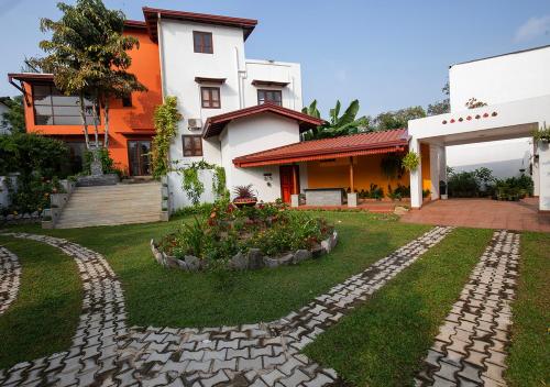 a house with a garden in front of it at Breeze of Paradise in Colombo