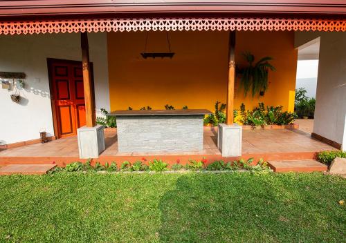 a house with a patio and a red door at Breeze of Paradise in Colombo