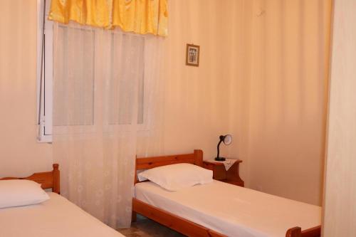 a bedroom with two beds and a window at Anastassia OG in Koroni