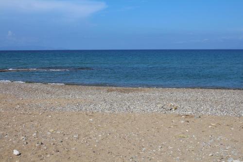 a rocky beach with the ocean in the background at Dionisios in Kástro Tornéze