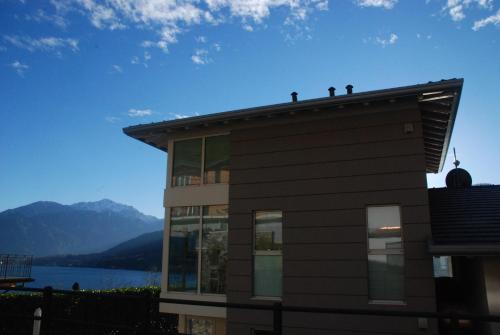 a house with a view of a lake and mountains at Residenza Simona in Mezzegra