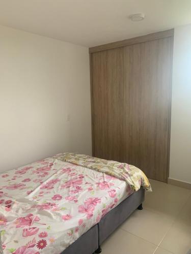 a bedroom with a bed with a floral blanket at Vacations in Playa Dormida