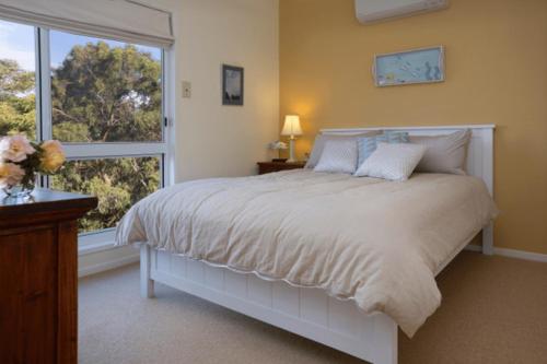 a bedroom with a large bed and a window at Mhara Downs Country Escape in Foster