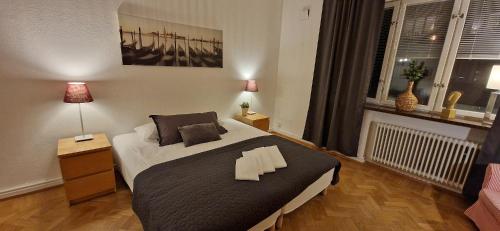 a bedroom with a bed with two pillows on it at City Apartments Triangeln in Malmö