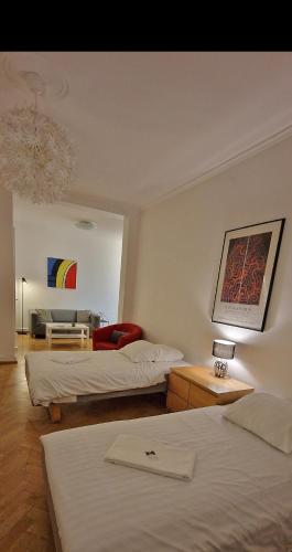 a hotel room with two beds and a couch at City Apartments Triangeln in Malmö