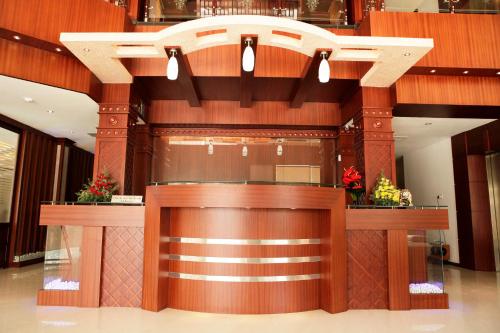 a lobby with a large wooden bar in a building at Athirappilly Residency Chalakudy in Kizhake Chālakudi