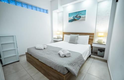 a bedroom with a bed with two towels on it at Tsolias Apartments in Protaras