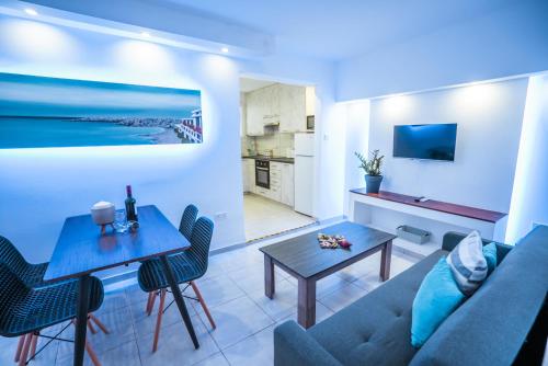 a living room with a couch and a table at Tsolias Apartments in Protaras