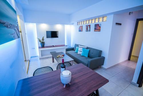 a living room with a table and a couch at Tsolias Apartments in Protaras