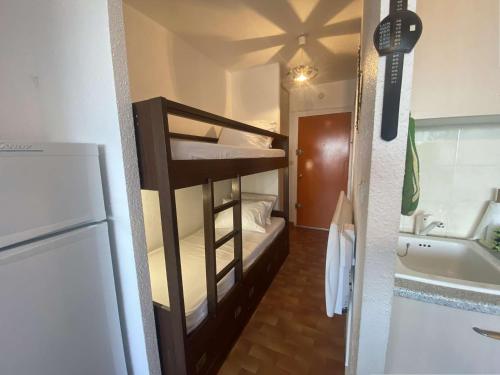 Cette petite chambre comprend des lits superposés et un réfrigérateur. dans l'établissement Studio cosy 4 pers, plage à pied, parking gratuit Port Camargue - FR-1-250-176, au Grau-du-Roi