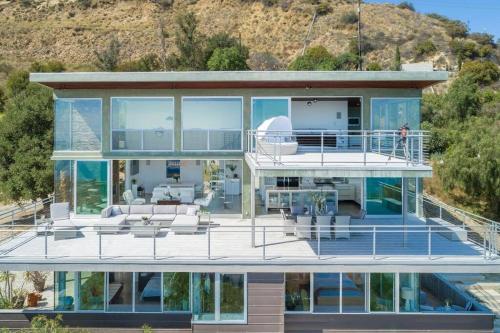 a large house with a large deck with glass at Malibu Glass House: Architectural w 180deg Views in Malibu