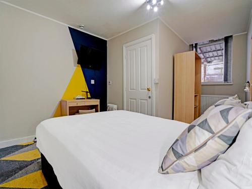 a bedroom with a large white bed and a window at Weaste Hotel, West Manchester Hotel in Manchester