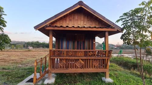 a small building with a roof on a field at DGD Chiangmai in Mae Rim