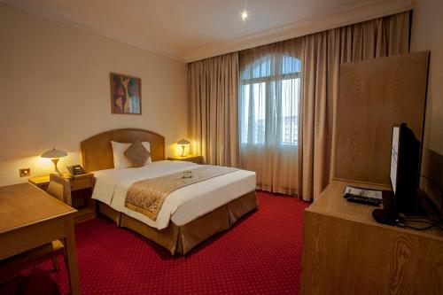 a hotel room with a bed and a television at HAFFA HOUSE HOTEL in Muscat