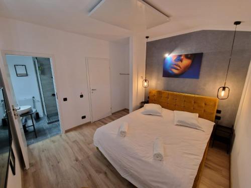 Harmony Apartment Poiana Brasov في بويانا براسوف: غرفة نوم مع سرير أبيض كبير في غرفة