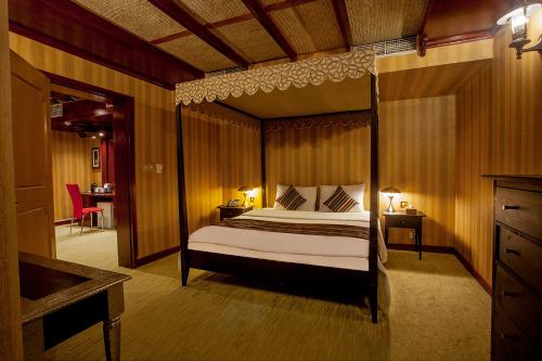 a bedroom with a canopy bed in a room at HAFFA HOUSE HOTEL in Muscat