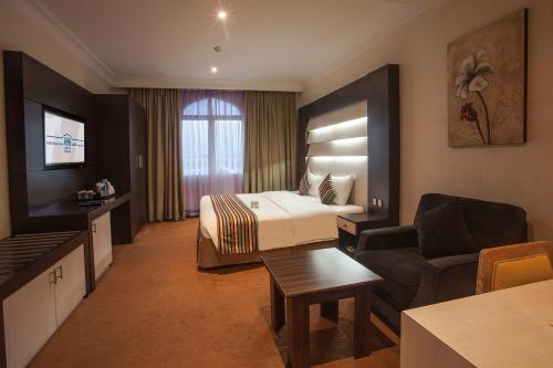 a hotel room with a bed and a couch at HAFFA HOUSE HOTEL in Muscat