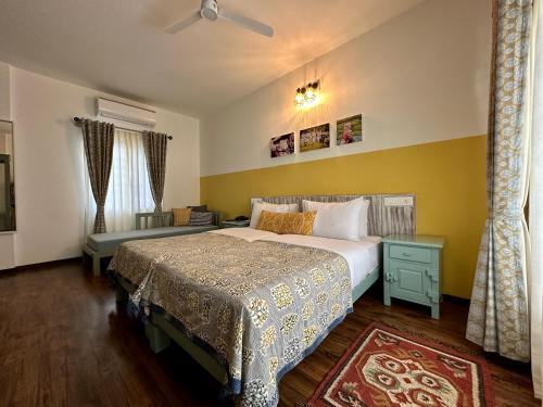 a bedroom with a large bed and a window at Machaan Wilderness Lodge Nagarahole in Srimangala