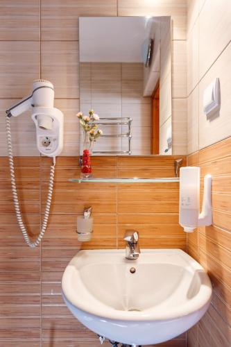 a bathroom with a sink and a mirror at GORGANY resort & SPA in Yablunytsya