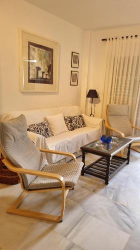 a living room with a couch and a coffee table at Hoyo 12 Islantilla in Huelva