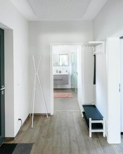 a living room with white walls and wooden floors at Stilapartment Loft in Wernigerode