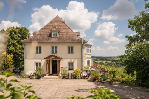 a large white house with a roof at Flair Hotel Villa Ilske in Bad Kösen